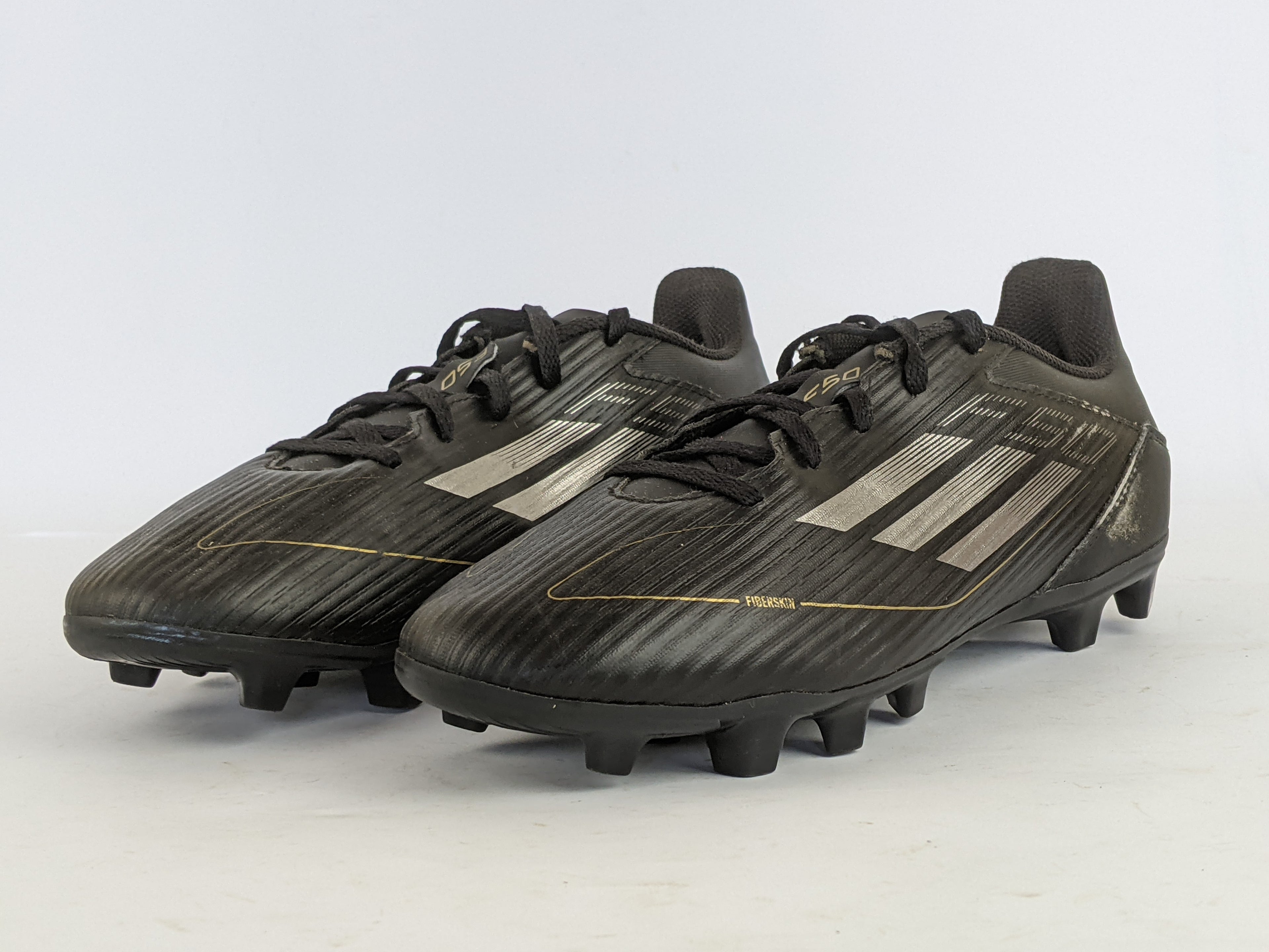 adidas F50 Club FxG Dark Spark - Core Black/Iron Metal/Gold Metallic