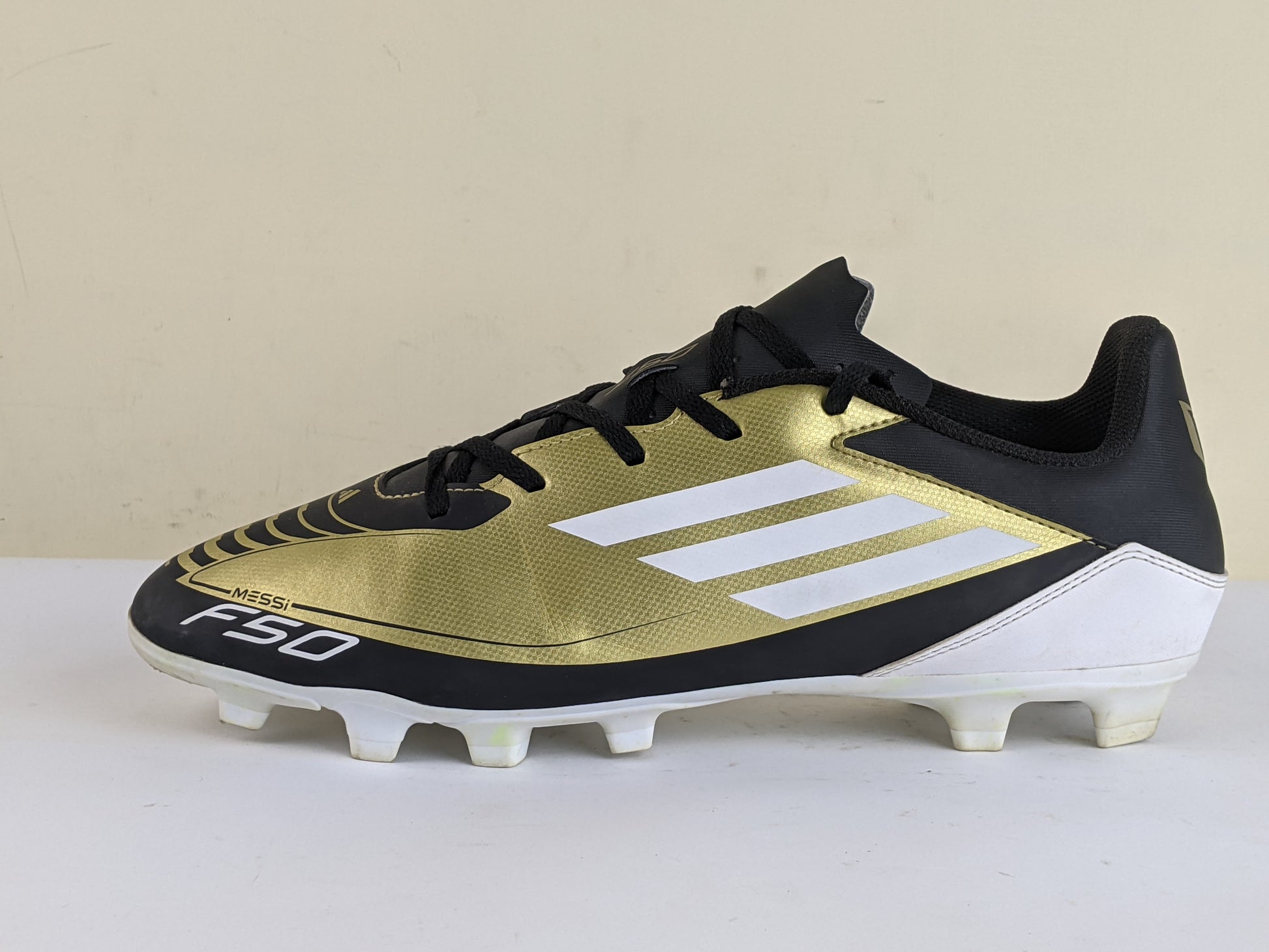 adidas F50 Messi Club FxG Triunfo Dorado - Gold Metallic/Footwear White/Core Black