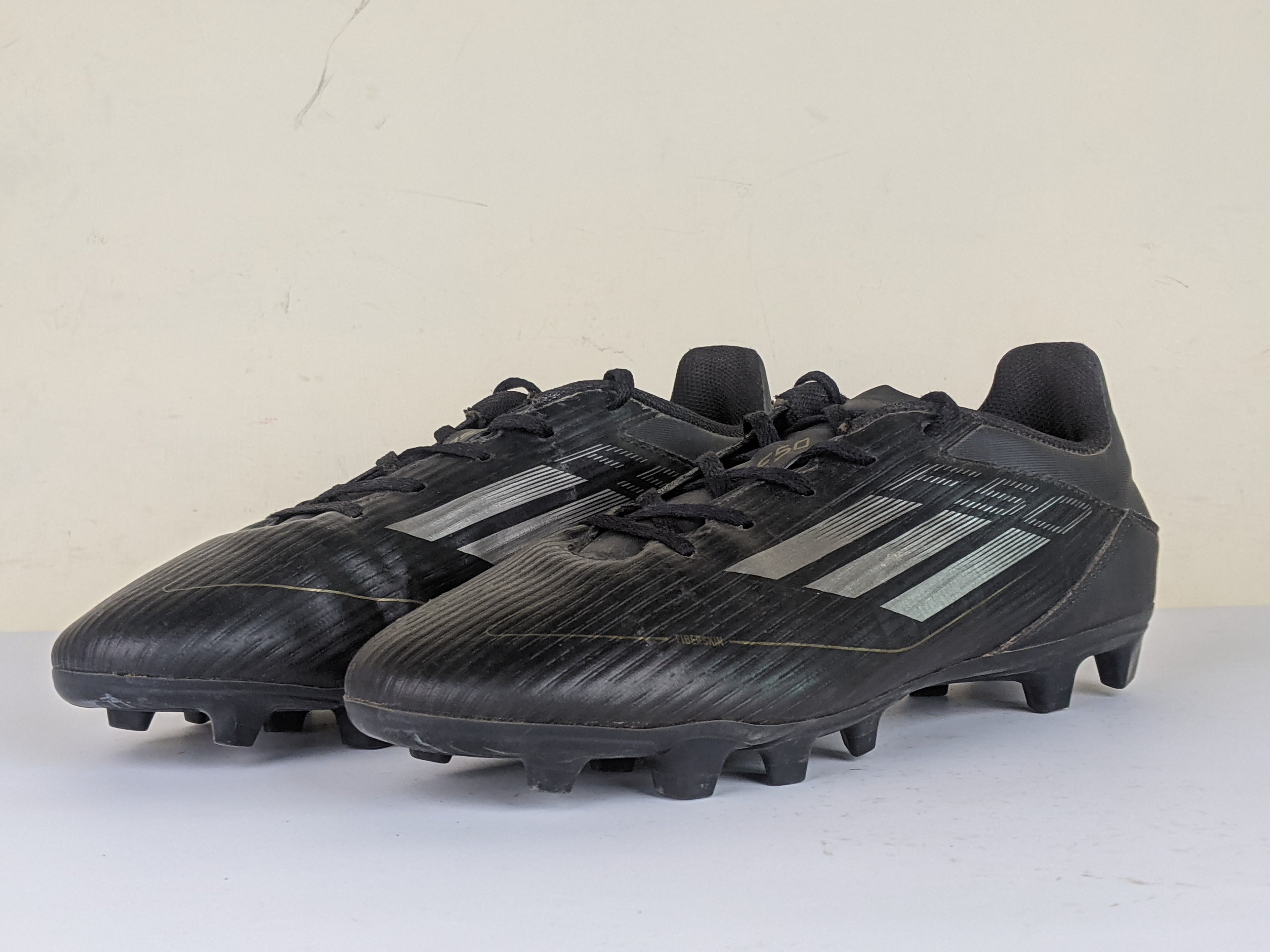 adidas F50 Club FxG Dark Spark - Core Black/Iron Metal/Gold Metallic